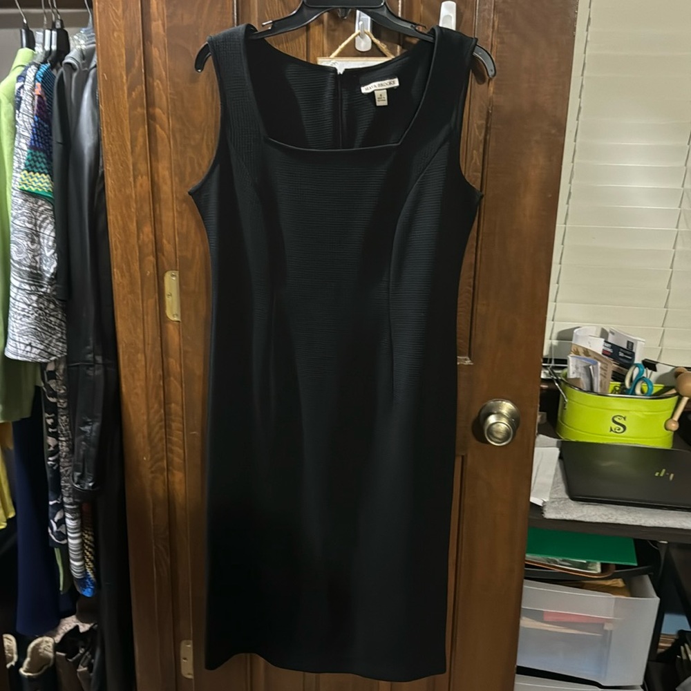 Sleeveless black dress with patterned short sleeve jacket. Versatile outfit.